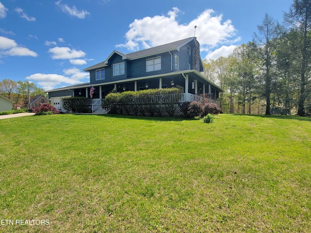 farmhouse inspired home with a porch, a front lawn, and a garage