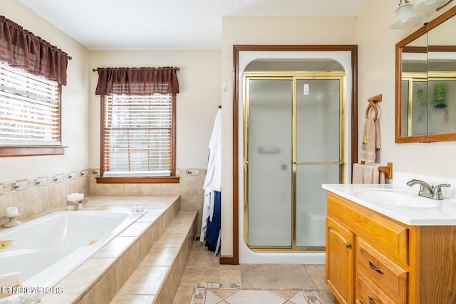 bathroom with tile patterned flooring, a shower stall, vanity, and a garden tub