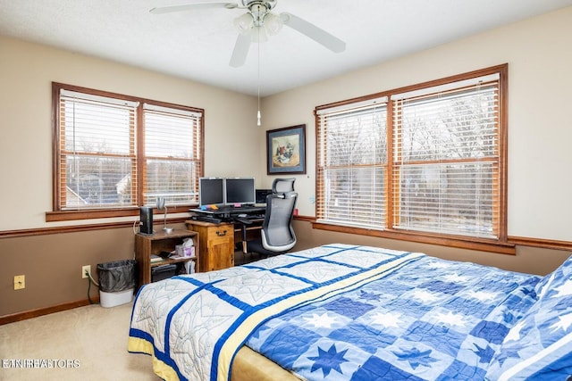 bedroom featuring baseboards, a ceiling fan, and carpet flooring