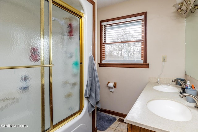 full bath with a sink, visible vents, double vanity, and tile patterned floors