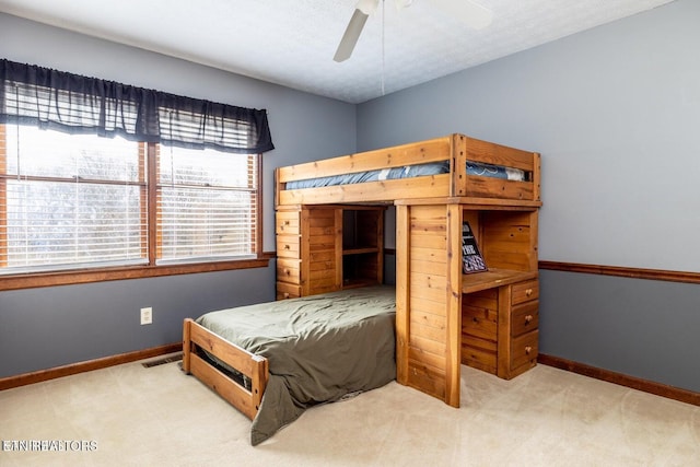 bedroom with baseboards, visible vents, carpet floors, and ceiling fan