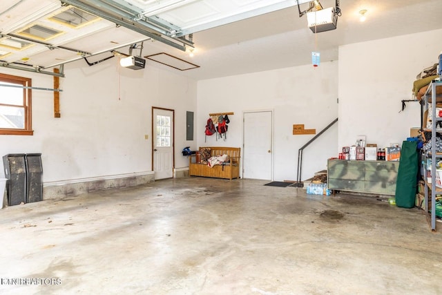 garage with electric panel and a garage door opener