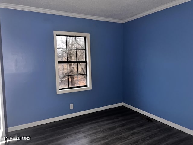 spare room with baseboards, a textured ceiling, ornamental molding, and dark wood-style flooring