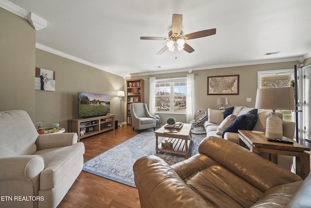 living area with visible vents, crown molding, a ceiling fan, and parquet floors