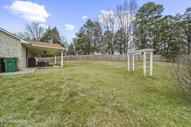 view of yard with a patio area, a ceiling fan, and a fenced backyard