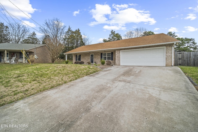 single story home with brick siding, a front yard, a garage, and fence