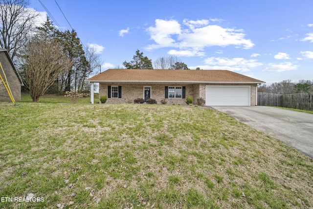 ranch-style home featuring brick siding, driveway, a front yard, and a garage