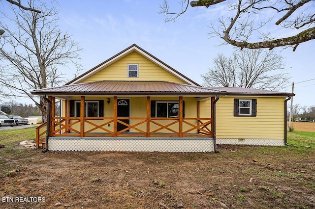 country-style home featuring crawl space, covered porch, and metal roof