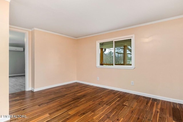 empty room featuring hardwood / wood-style floors, an AC wall unit, crown molding, and baseboards