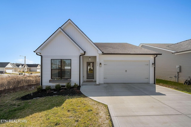 view of front of home featuring a garage, a front lawn, driveway, and a shingled roof