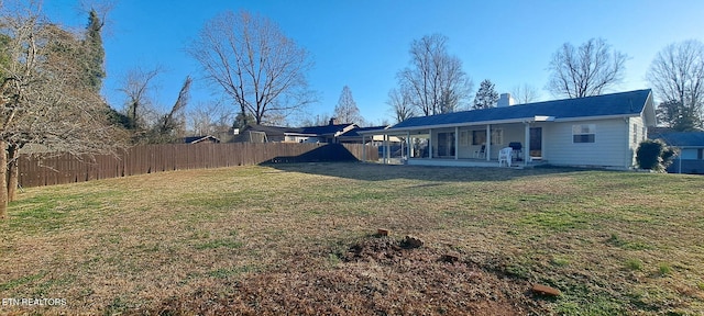 107 W Pawley Rd, Oak Ridge, TN 37830 - rear view of house featuring fence, a chimney, a lawn, and a patio area