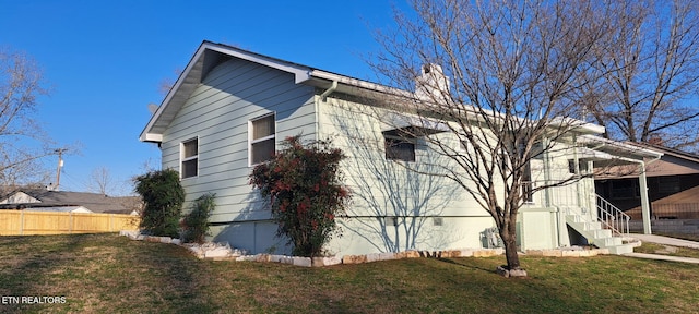 107 W Pawley Rd, Oak Ridge, TN 37830 - view of home's exterior with fence, a chimney, a yard, and crawl space