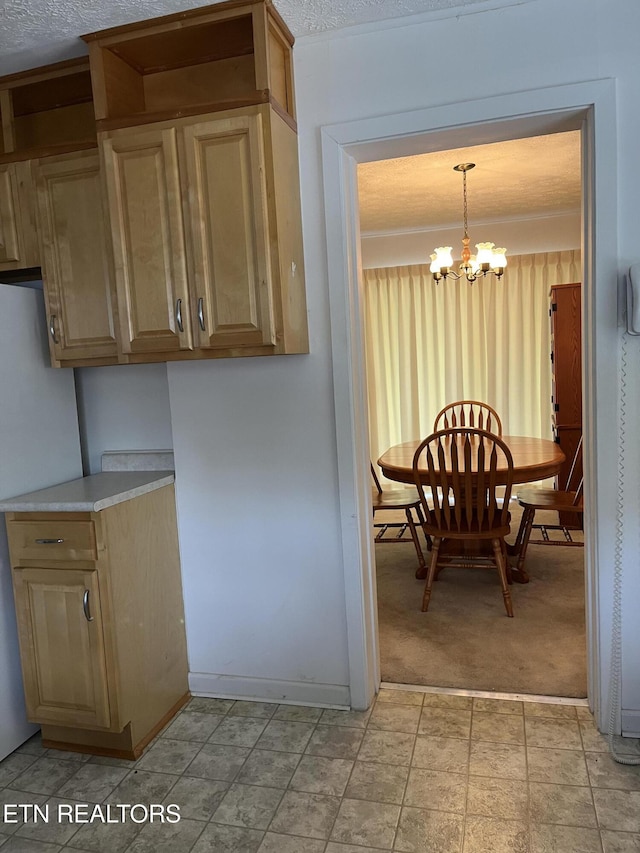 107 W Pawley Rd, Oak Ridge, TN 37830 - kitchen featuring light carpet, light countertops, a chandelier, decorative light fixtures, and stone finish flooring