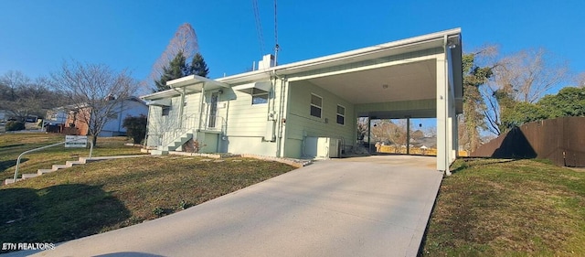 107 W Pawley Rd, Oak Ridge, TN 37830 - exterior space featuring fence, a lawn, an attached carport, and concrete driveway