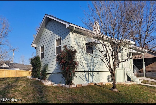 107 W Pawley Rd, Oak Ridge, TN 37830 - view of home's exterior with fence, a chimney, a yard, and crawl space
