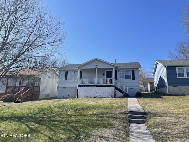 bungalow-style home featuring a front lawn, stairway, and crawl space