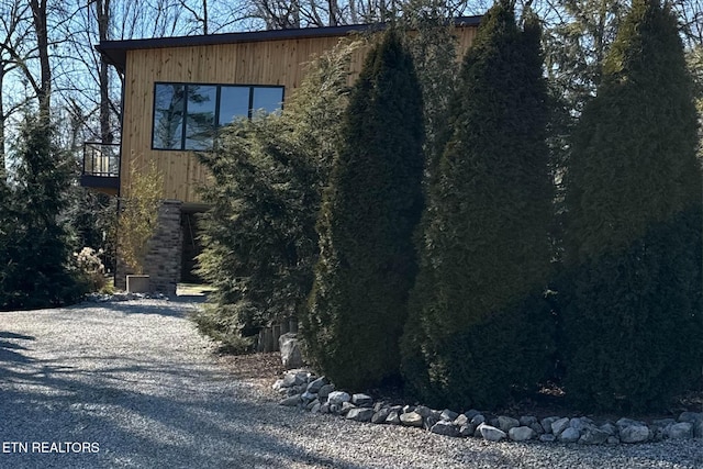 view of home's exterior with gravel driveway