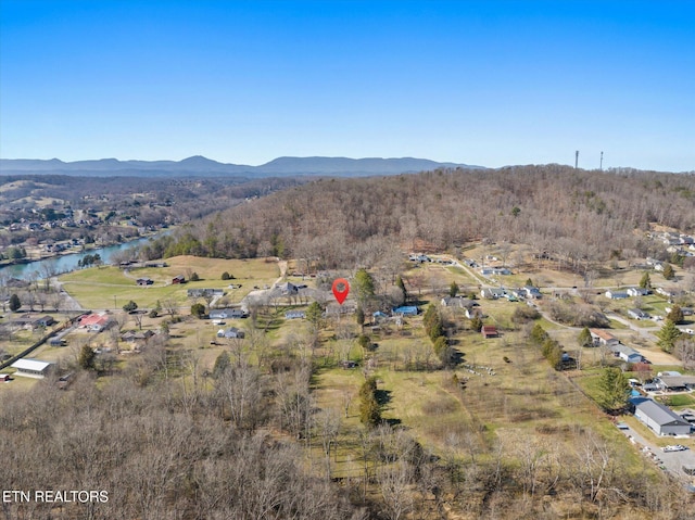 drone / aerial view with a water and mountain view