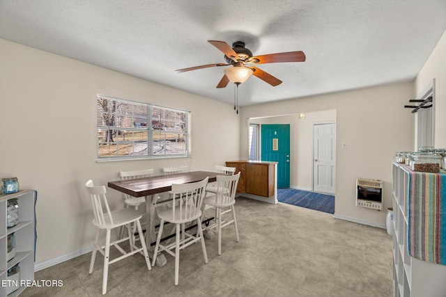 dining area featuring baseboards, heating unit, a textured ceiling, and a ceiling fan