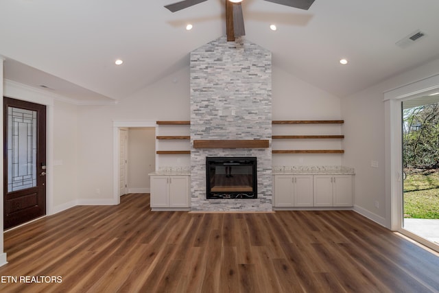 unfurnished living room with beam ceiling, a fireplace, high vaulted ceiling, and wood finished floors