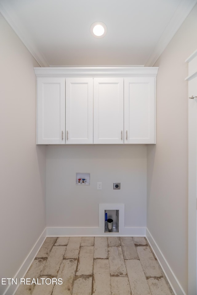 laundry room with cabinet space, crown molding, baseboards, hookup for an electric dryer, and hookup for a washing machine