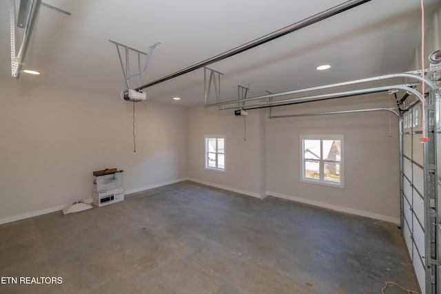 garage with a garage door opener and baseboards