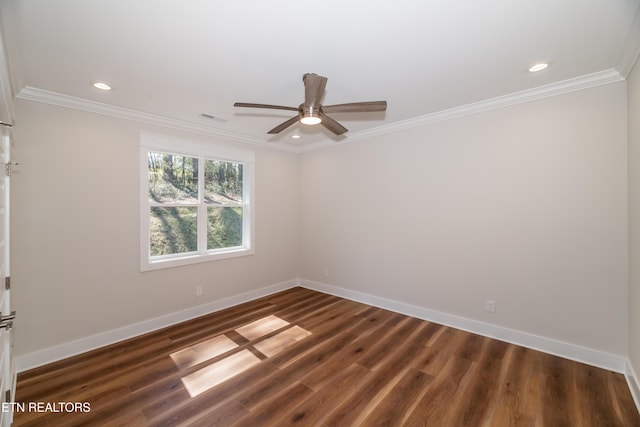 spare room featuring visible vents, baseboards, ornamental molding, and dark wood finished floors