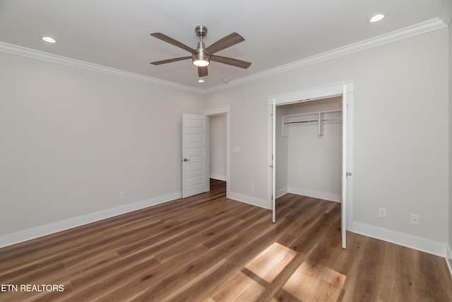 unfurnished bedroom with baseboards, wood finished floors, and ornamental molding