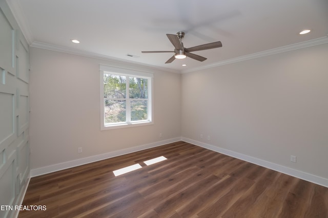 unfurnished room featuring dark wood finished floors, visible vents, and ornamental molding