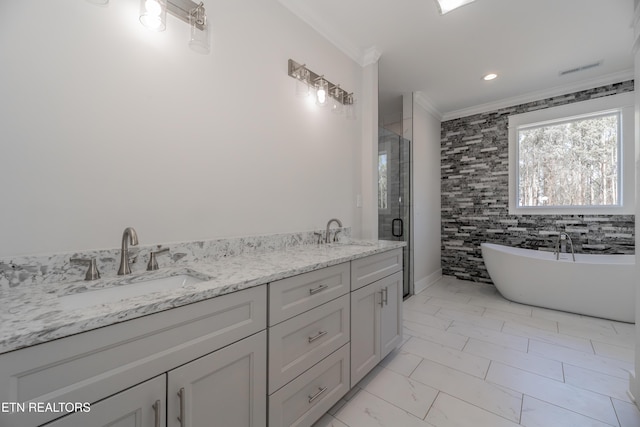 bathroom with crown molding, a stall shower, marble finish floor, and a sink