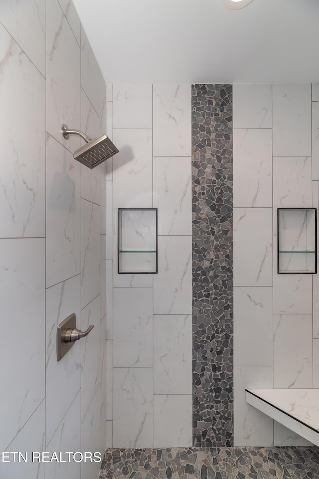 bathroom featuring a tile shower