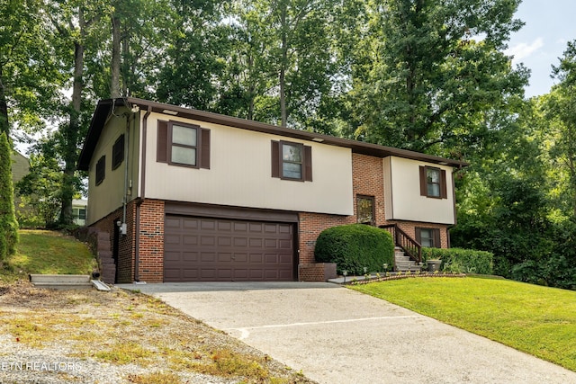 split foyer home with a garage, brick siding, concrete driveway, and a front lawn