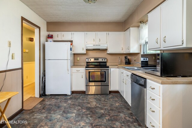 kitchen featuring under cabinet range hood, a sink, white cabinetry, stainless steel appliances, and light countertops