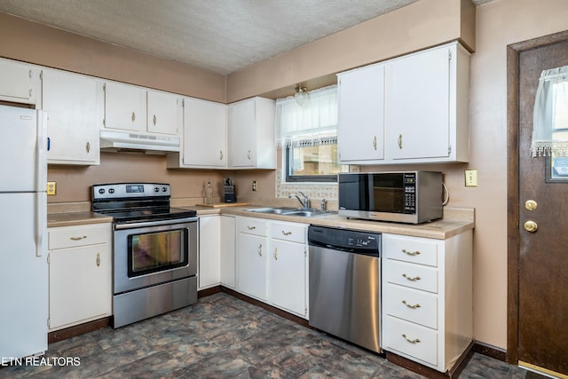 kitchen featuring under cabinet range hood, light countertops, stainless steel appliances, white cabinetry, and a sink