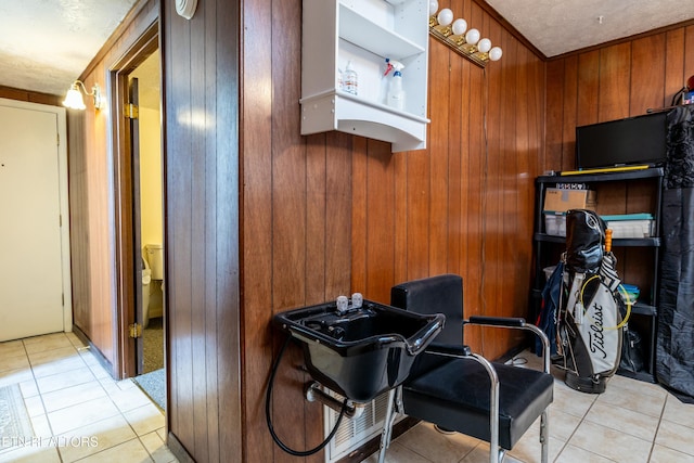 interior space featuring light tile patterned floors and wood walls