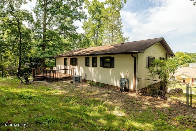 back of house with a lawn, a deck, and fence