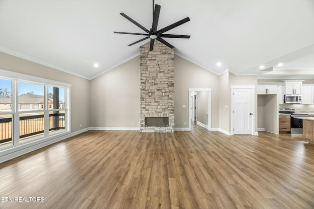 unfurnished living room featuring light wood-style flooring, a ceiling fan, ornamental molding, a fireplace, and baseboards