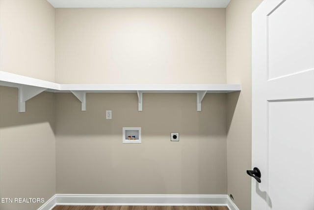 clothes washing area featuring baseboards, hookup for an electric dryer, hookup for a washing machine, and laundry area