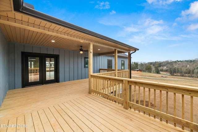 wooden terrace featuring a ceiling fan