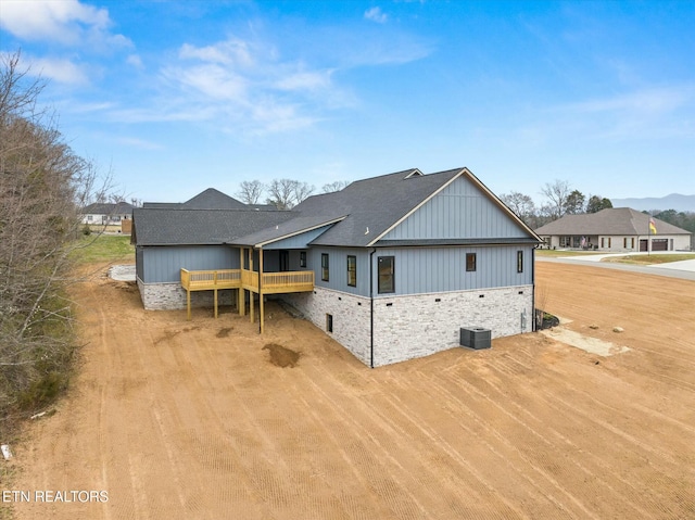 rear view of property with a wooden deck