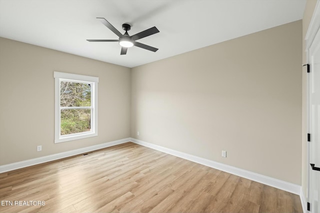 spare room with light wood-style flooring, baseboards, and ceiling fan