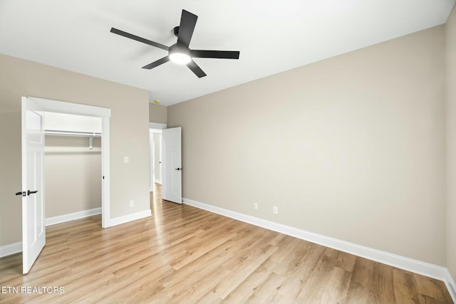 unfurnished bedroom featuring a closet, baseboards, light wood-style floors, and a ceiling fan