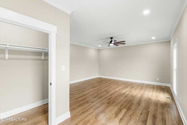 unfurnished bedroom featuring crown molding, light wood-style floors, baseboards, and visible vents