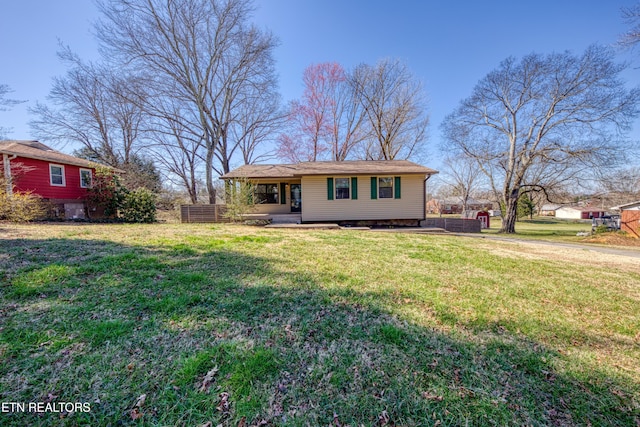 view of front of property with a front lawn and fence