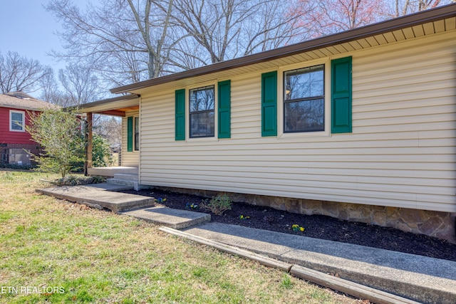 view of side of property with a yard