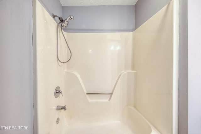 full bath with a textured ceiling