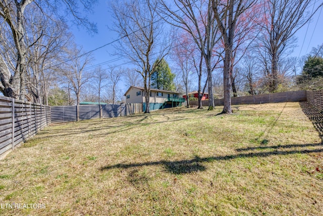 view of yard with a fenced backyard