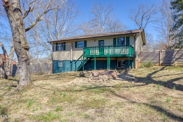 back of house with a wooden deck, a fenced backyard, and stairs