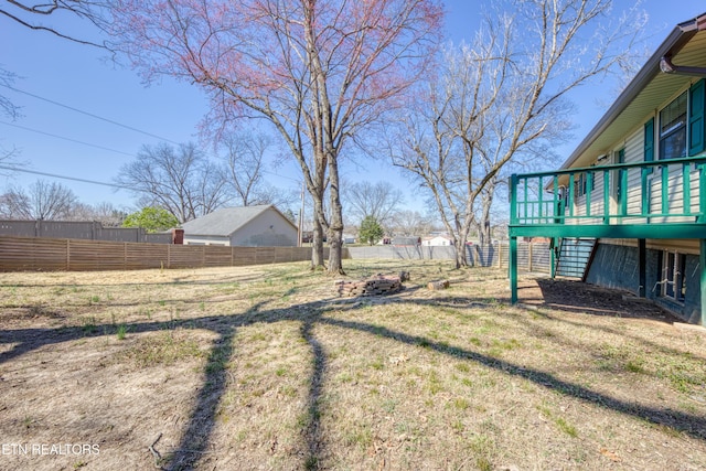 view of yard featuring fence and a wooden deck