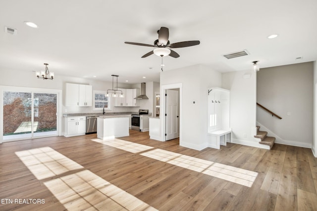 unfurnished living room with recessed lighting, visible vents, and light wood-type flooring